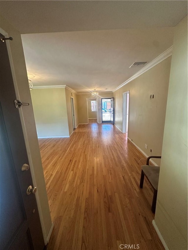 7918 Kyle St, Sunland, CA 91040 - hallway featuring wood finished floors, ornamental molding, baseboards, and a chandelier