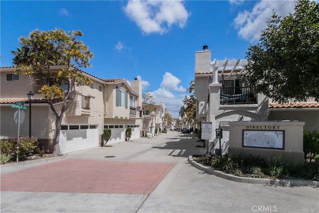 view of road featuring a residential view and curbs