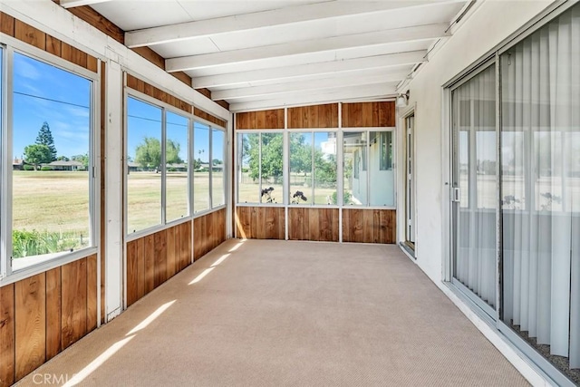 unfurnished sunroom with beamed ceiling