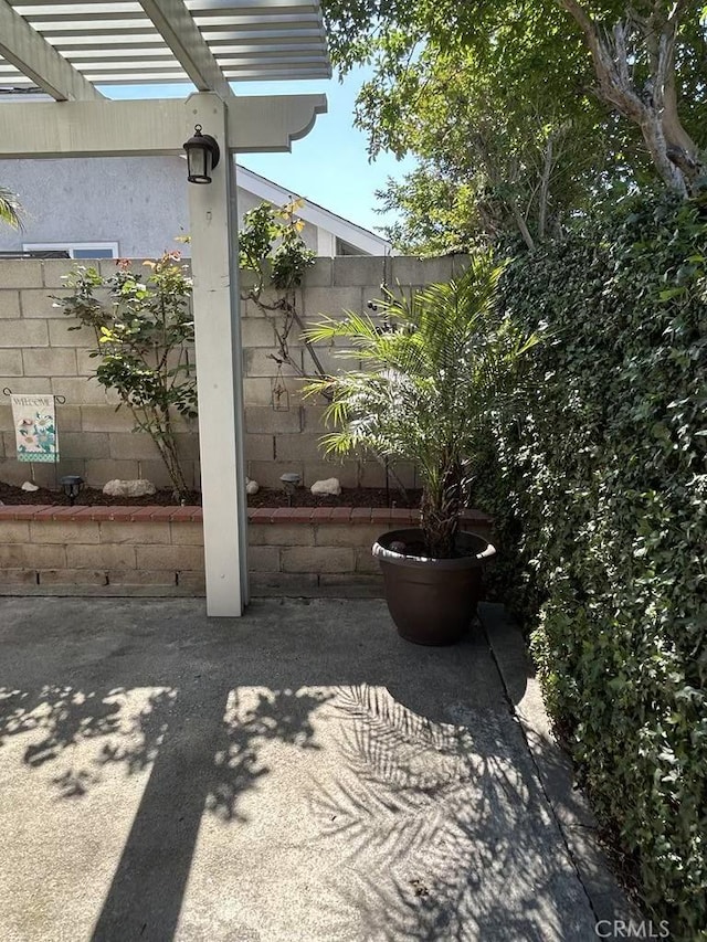 view of patio / terrace with a pergola and fence