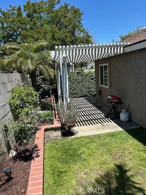 view of yard with a pergola and a patio