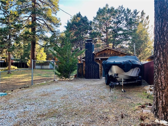 712 San Bernardino Ave, Sugarloaf, CA 92386 - view of home's exterior with a chimney and fence