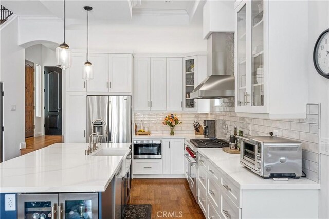 1715 Reed St, Redondo Beach, CA 90278 - kitchen with wall chimney exhaust hood, beverage cooler, appliances with stainless steel finishes, ornamental molding, and dark wood-type flooring
