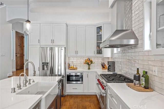 1715 Reed St, Redondo Beach, CA 90278 - kitchen featuring wall chimney exhaust hood, appliances with stainless steel finishes, white cabinets, pendant lighting, and decorative backsplash