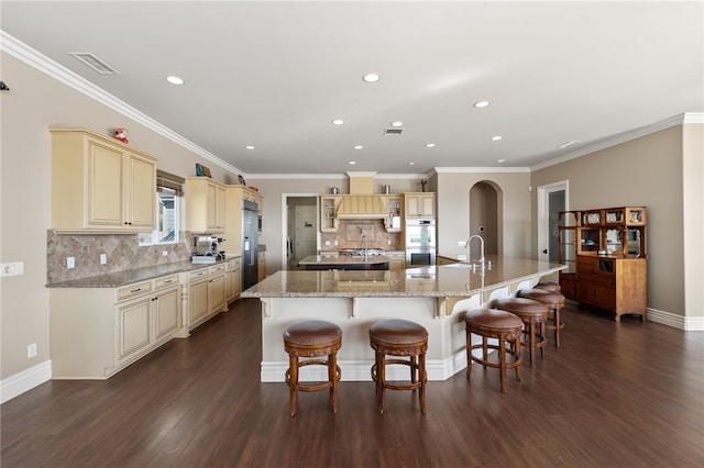 40267 Scanlon Rd, Temecula, CA 92592 - kitchen with cream cabinetry, stainless steel appliances, recessed lighting, decorative backsplash, and dark wood-style floors