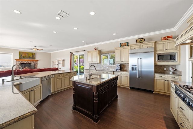 40267 Scanlon Rd, Temecula, CA 92592 - kitchen with built in appliances, cream cabinets, a sink, crown molding, and recessed lighting