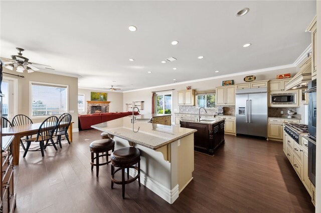 40267 Scanlon Rd, Temecula, CA 92592 - kitchen with built in appliances, cream cabinetry, a spacious island, a sink, and ceiling fan