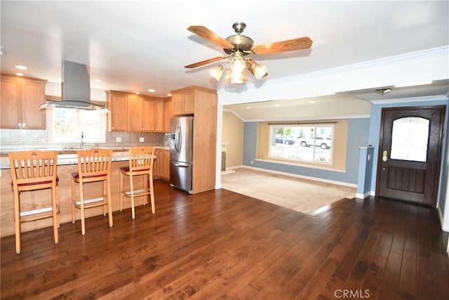 5309 Emerald St, Torrance, CA 90503 - kitchen with stainless steel fridge, island range hood, light countertops, ornamental molding, and tasteful backsplash