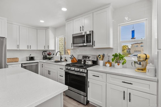 852 5th St, Imperial Beach, CA 91932 - kitchen featuring appliances with stainless steel finishes, a sink, tasteful backsplash, white cabinets, and recessed lighting