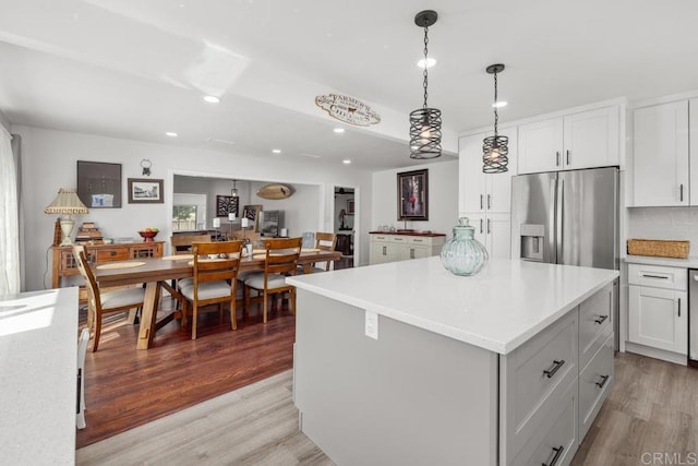 852 5th St, Imperial Beach, CA 91932 - kitchen with stainless steel fridge with ice dispenser, light wood finished floors, recessed lighting, light countertops, and a center island