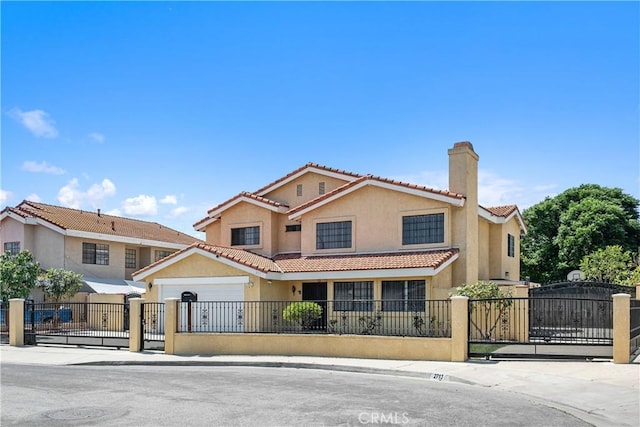 view of front of property featuring stucco siding, a fenced front yard, a gate, and a tiled roof