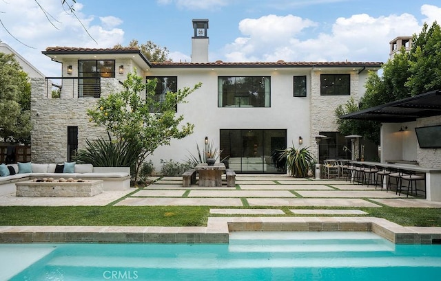 10 Seabluff, Newport Beach, CA 92660 - back of property featuring a fire pit, a patio, a chimney, and an outdoor pool