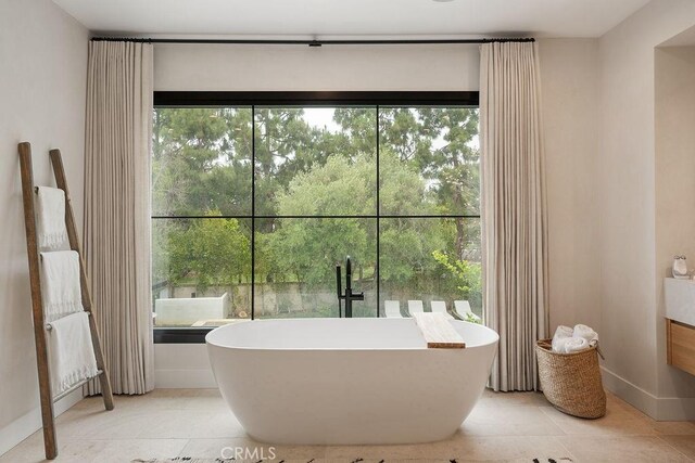 10 Seabluff, Newport Beach, CA 92660 - bathroom featuring a freestanding bath, baseboards, and tile patterned flooring