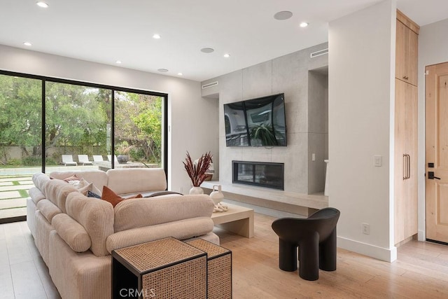 10 Seabluff, Newport Beach, CA 92660 - living room with light wood-type flooring, a high end fireplace, recessed lighting, and baseboards