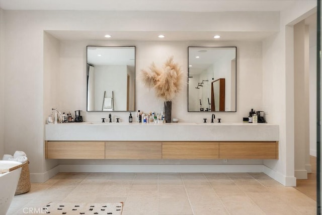10 Seabluff, Newport Beach, CA 92660 - bathroom with double vanity, recessed lighting, baseboards, and a freestanding tub