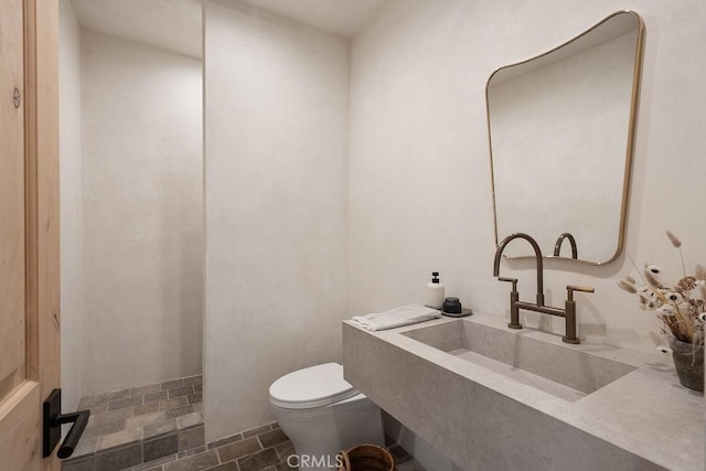 10 Seabluff, Newport Beach, CA 92660 - bathroom featuring toilet, a sink, and stone finish flooring