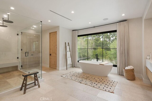 10 Seabluff, Newport Beach, CA 92660 - bathroom with a stall shower, a freestanding bath, recessed lighting, and baseboards