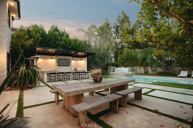 10 Seabluff, Newport Beach, CA 92660 - patio terrace at dusk with a patio area, a pool with connected hot tub, and area for grilling