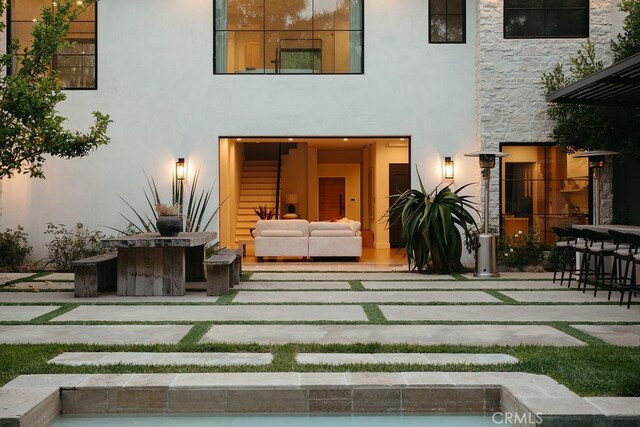 10 Seabluff, Newport Beach, CA 92660 - back of house with stucco siding, an outdoor hangout area, a patio, an outdoor bar, and stone siding