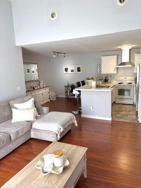 15000 Downey Ave Unit 273, Paramount, CA 90723 - living room with wood finished floors and rail lighting