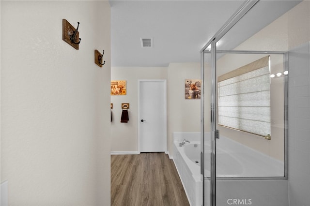 37628 Flora Ct, Murrieta, CA 92563 - bathroom with a garden tub, wood finished floors, a shower stall, and baseboards