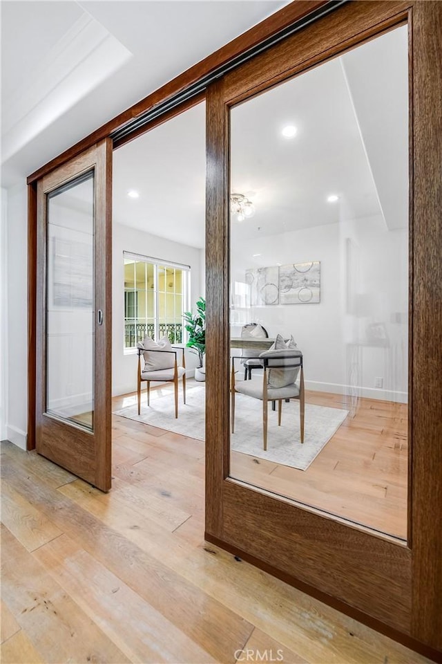 entryway with light wood finished floors and baseboards