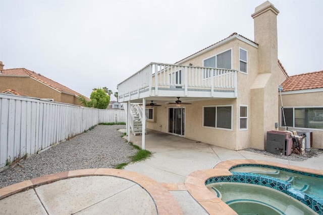28679 Corte Capri, Menifee, CA 92584 - rear view of property featuring an in-ground hot tub, ceiling fan, stucco siding, stairway, and a fenced backyard