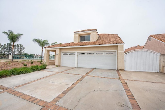 28679 Corte Capri, Menifee, CA 92584 - view of front of property featuring stucco siding, concrete driveway, a gate, a tiled roof, and an attached garage