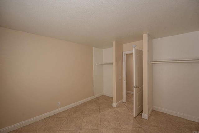 28679 Corte Capri, Menifee, CA 92584 - unfurnished bedroom with light tile patterned flooring, a textured ceiling, and baseboards