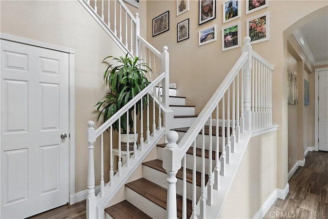 1958 Fall Brook Ct, Merced, CA 95340 - stairs with arched walkways, wood finished floors, and baseboards