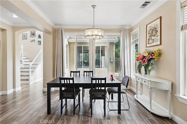 1958 Fall Brook Ct, Merced, CA 95340 - dining space with baseboards, a chandelier, dark wood finished floors, and ornamental molding