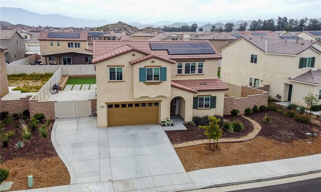 28400 Memory Ln, Winchester, CA 92596 - mediterranean / spanish-style house with a tile roof, a fenced backyard, a gate, stucco siding, and roof mounted solar panels