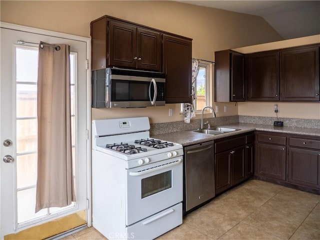 66659 El Dorado Pl, Desert Hot Springs, CA 92240 - kitchen with appliances with stainless steel finishes, dark brown cabinetry, light tile patterned floors, and vaulted ceiling