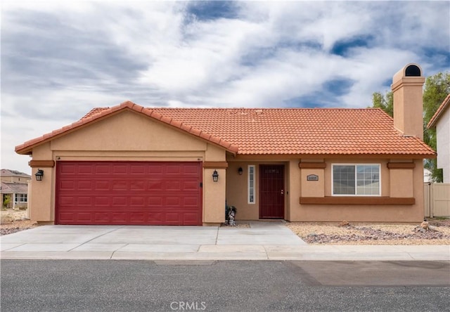 66659 El Dorado Pl, Desert Hot Springs, CA 92240 - view of front facade featuring stucco siding, an attached garage, concrete driveway, a tile roof, and a chimney