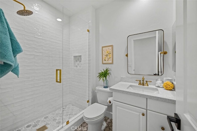 full bath featuring toilet, a stall shower, and vanity