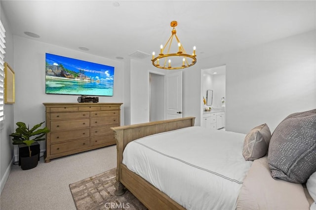 carpeted bedroom featuring a chandelier, baseboards, and ensuite bathroom