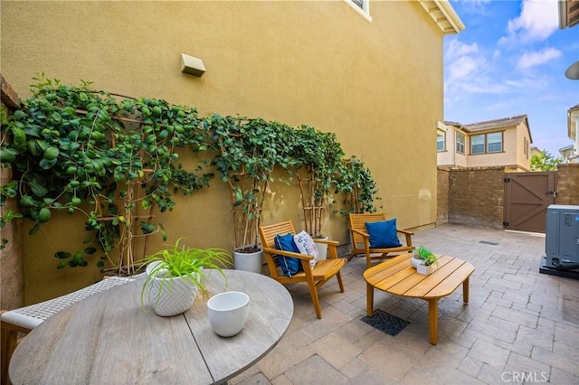 view of patio featuring a gate and fence