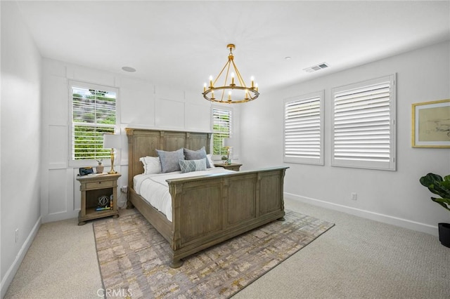 bedroom with light carpet, multiple windows, and baseboards