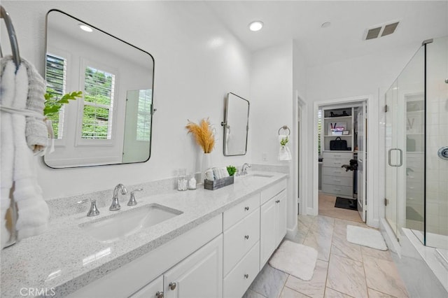 full bath with a stall shower, double vanity, recessed lighting, and marble finish flooring