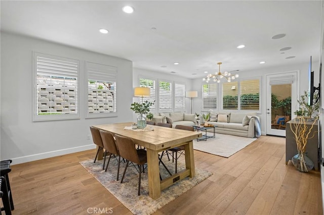 dining space featuring a chandelier, light wood-type flooring, baseboards, and recessed lighting