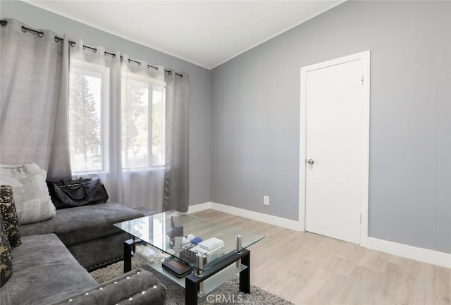 7700 Goodland Ave, North Hollywood, CA 91605 - living room with crown molding, light wood-style floors, baseboards, and vaulted ceiling