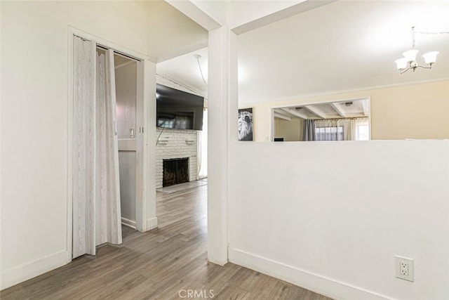 7700 Goodland Ave, North Hollywood, CA 91605 - corridor featuring wood finished floors, a chandelier, and baseboards