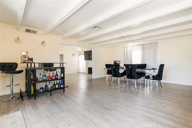 7700 Goodland Ave, North Hollywood, CA 91605 - dining room with baseboards, wood finished floors, and beam ceiling