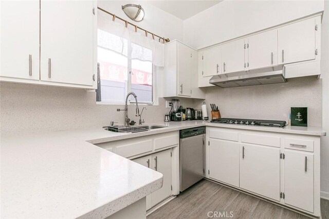 7700 Goodland Ave, North Hollywood, CA 91605 - kitchen featuring dishwasher, a sink, under cabinet range hood, stovetop, and light countertops