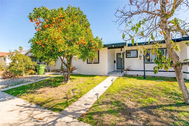7700 Goodland Ave, North Hollywood, CA 91605 - view of front facade featuring stucco siding and a front yard