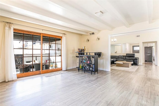 7700 Goodland Ave, North Hollywood, CA 91605 - living area with wood finished floors, healthy amount of natural light, beamed ceiling, and baseboards