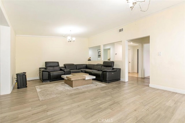 7700 Goodland Ave, North Hollywood, CA 91605 - living room featuring a chandelier, light wood-type flooring, baseboards, and crown molding