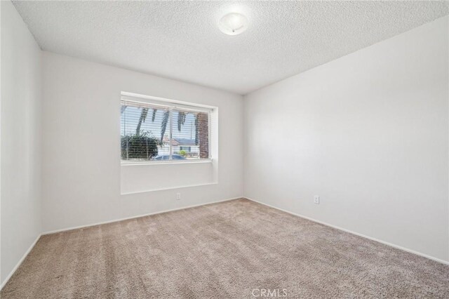 40389 Melrose Ave, Hemet, CA 92544 - empty room with carpet floors, a textured ceiling, and baseboards