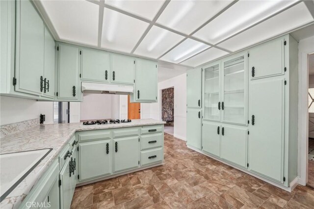 40389 Melrose Ave, Hemet, CA 92544 - kitchen with under cabinet range hood, a sink, light countertops, white gas cooktop, and green cabinets