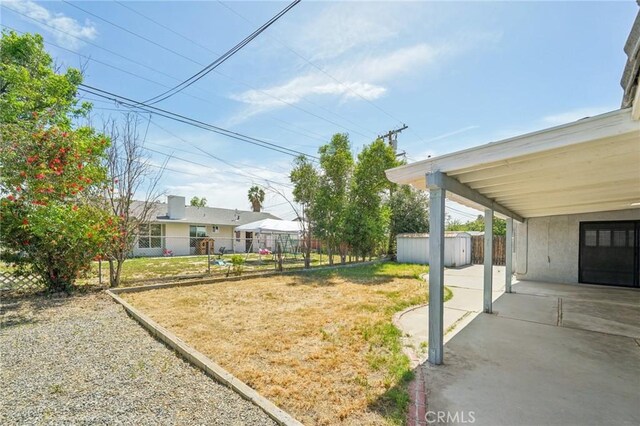 40389 Melrose Ave, Hemet, CA 92544 - view of yard featuring a storage shed, an outbuilding, a patio area, and a carport